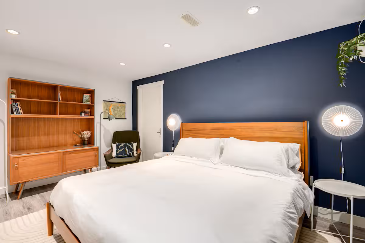 The main bedroom, with a king bed against a navy wall